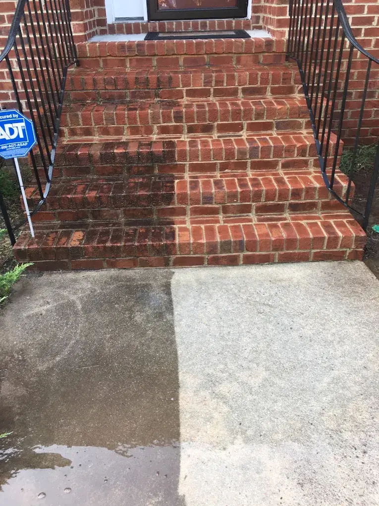Brick front steps and concrete walk half cleaned showing the before and after